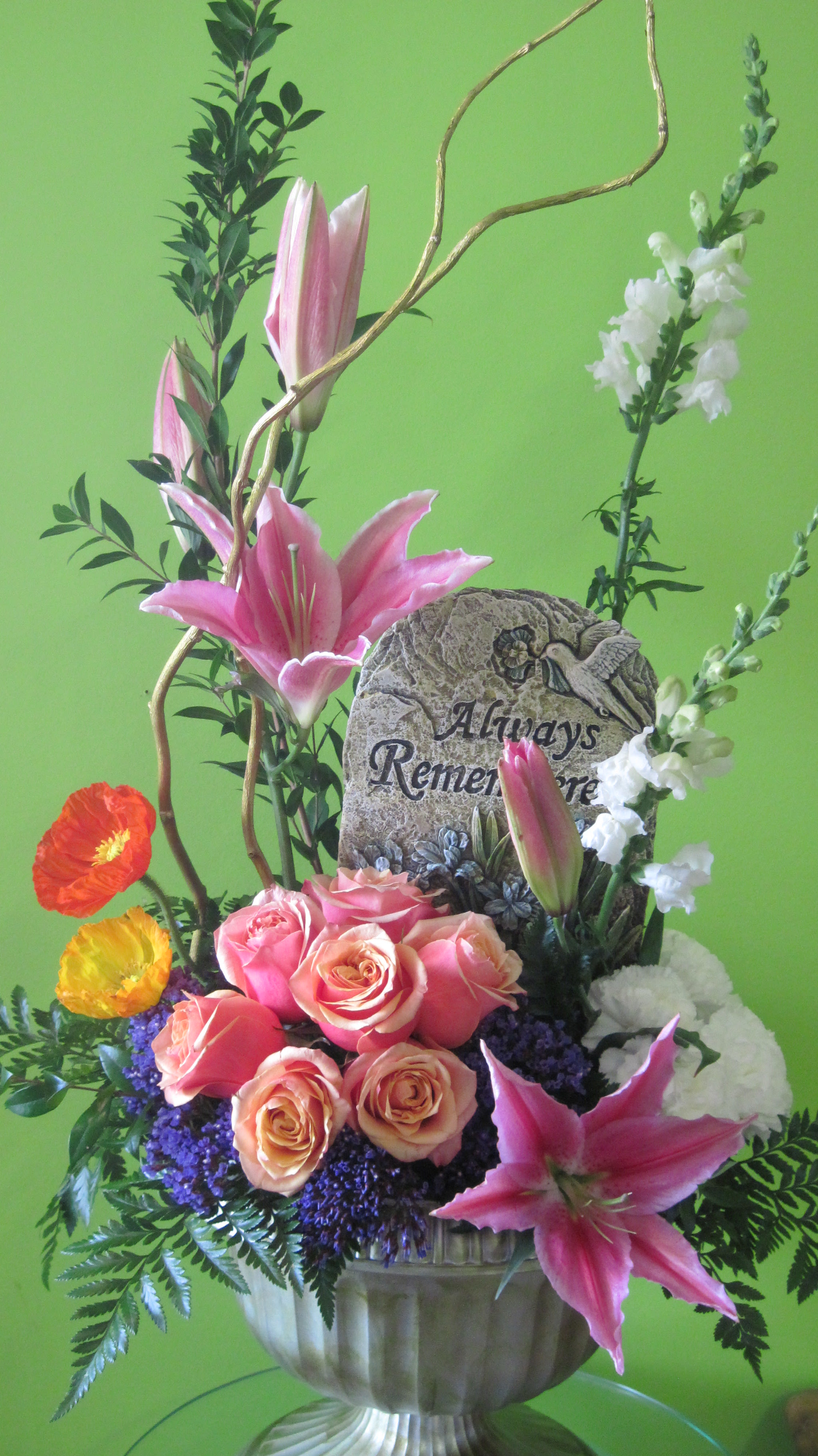 Sympathy Blooms Eternal Sympathy Blooms Eternal - This lovely mix of seasonal flower is a wonderful way to send condolences to a family. The addition of the small concrete stepping stone makes this an eternal keepsake. *Substitutions can be made for flower availability. Stone sayings may vary.