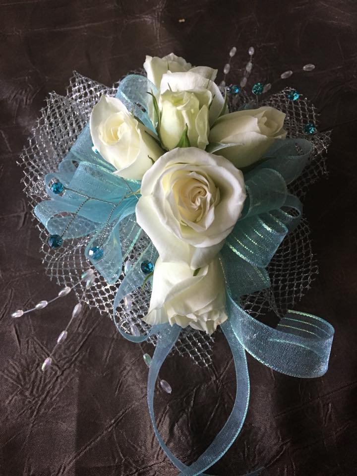 White rose bouquet with blue ribbon and silver mesh wrap