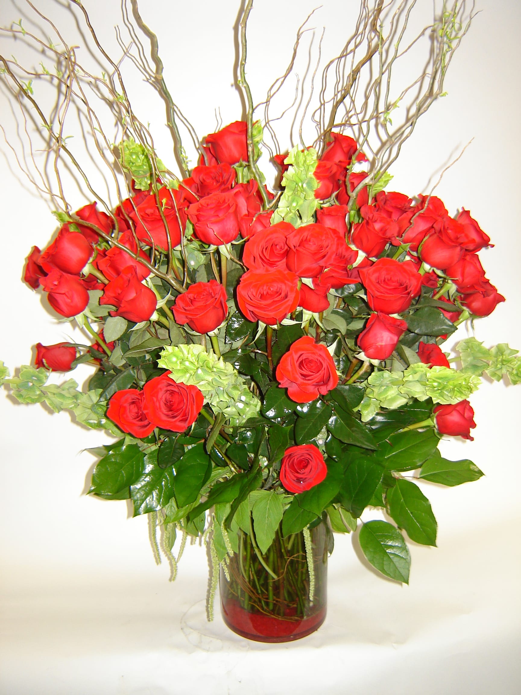 Forever Love Forever Love - For the love that lasts forever, roses accented with bells of Ireland and curly willow make a bold statement for the love in your life