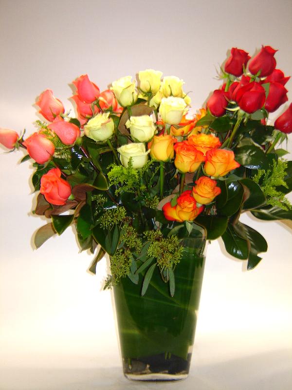 Bouquet of Love Bouquet of Love - This mixture of 36 Roses and greens will show your love ones how much they mean to you. Peach, White, Yellow, Orange and Classic Red roses make this arrangement come alive