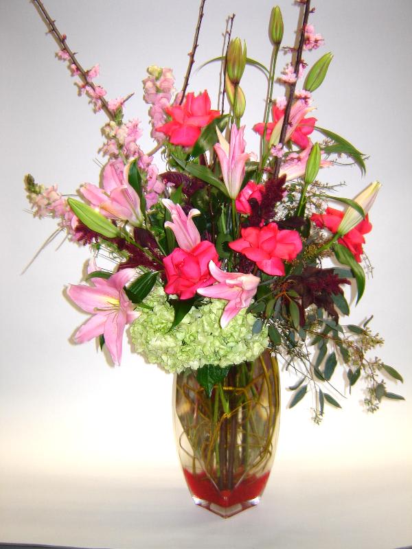 Pink Passion Pink Passion - A display of various pinks and greens makes this precious arrangement for the pink enthusiast with roses, lilies, snapdragons, blossom branches, hydrangea and seeded eucalyptus