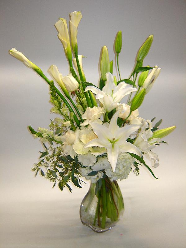 Classic Romance Classic Romance - Stunning lilies, white roses, casablanca white lilies, snapdragons, hydrangea accented with seeded eucalyptus