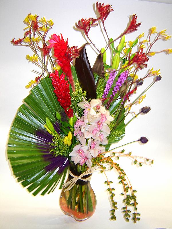 Artist's Palette Artist's Palette - An artsy arrangement with greens that look like an artist's palette and colorful flowers including ginger, kangaroo paw, lilies, cymbidium orchids and berries.