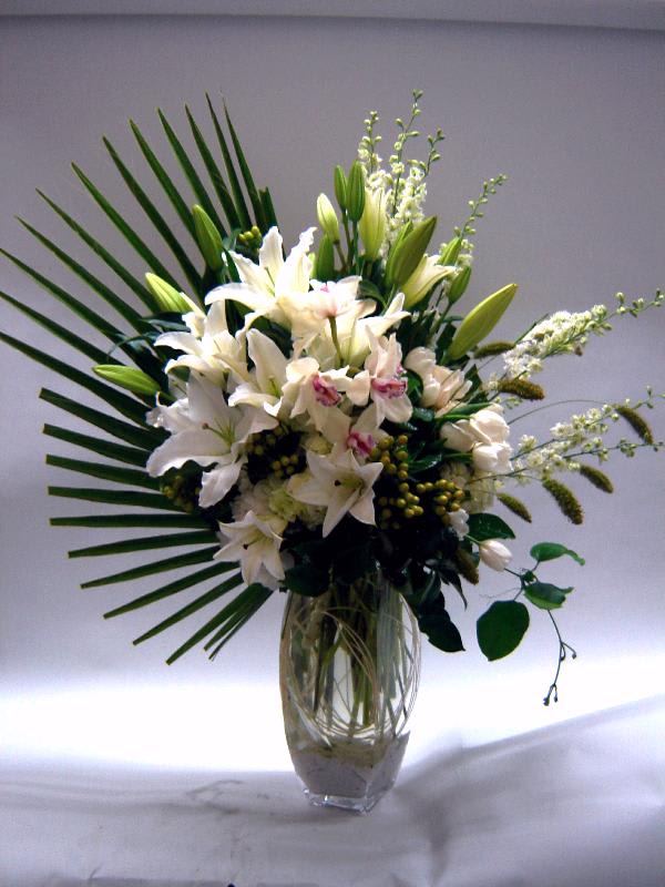 Fresh Brilliance - A dazzling vase arrangement with Casablanca lilies, cymbidium orchids, larkspur, hybericum berries, hydrangea and tulip.