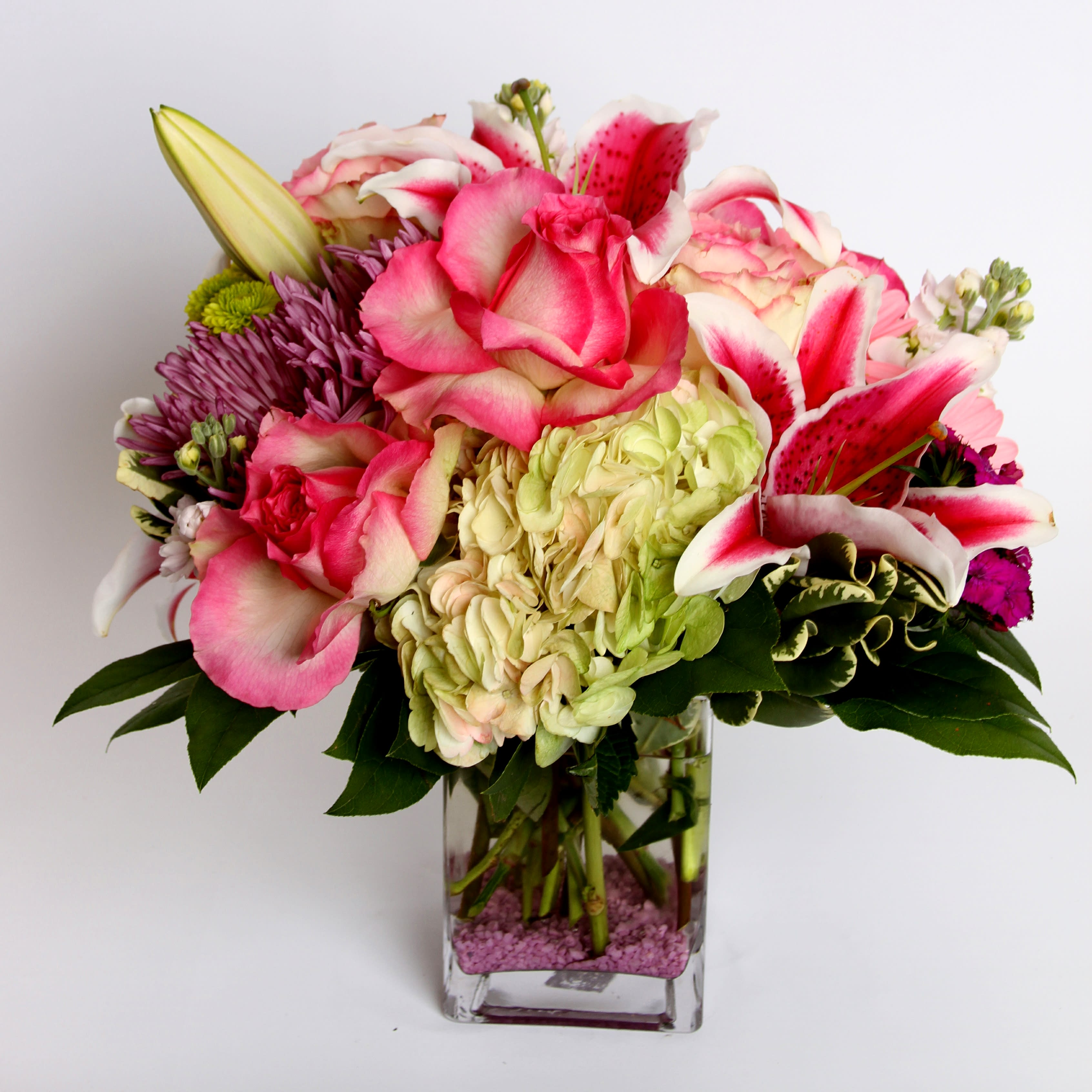 Lovely Lilies Lovely Lilies - Beautiful stargazers, pink roses, hydrangea, spider mums and stock in a feminine pink vase arrangement