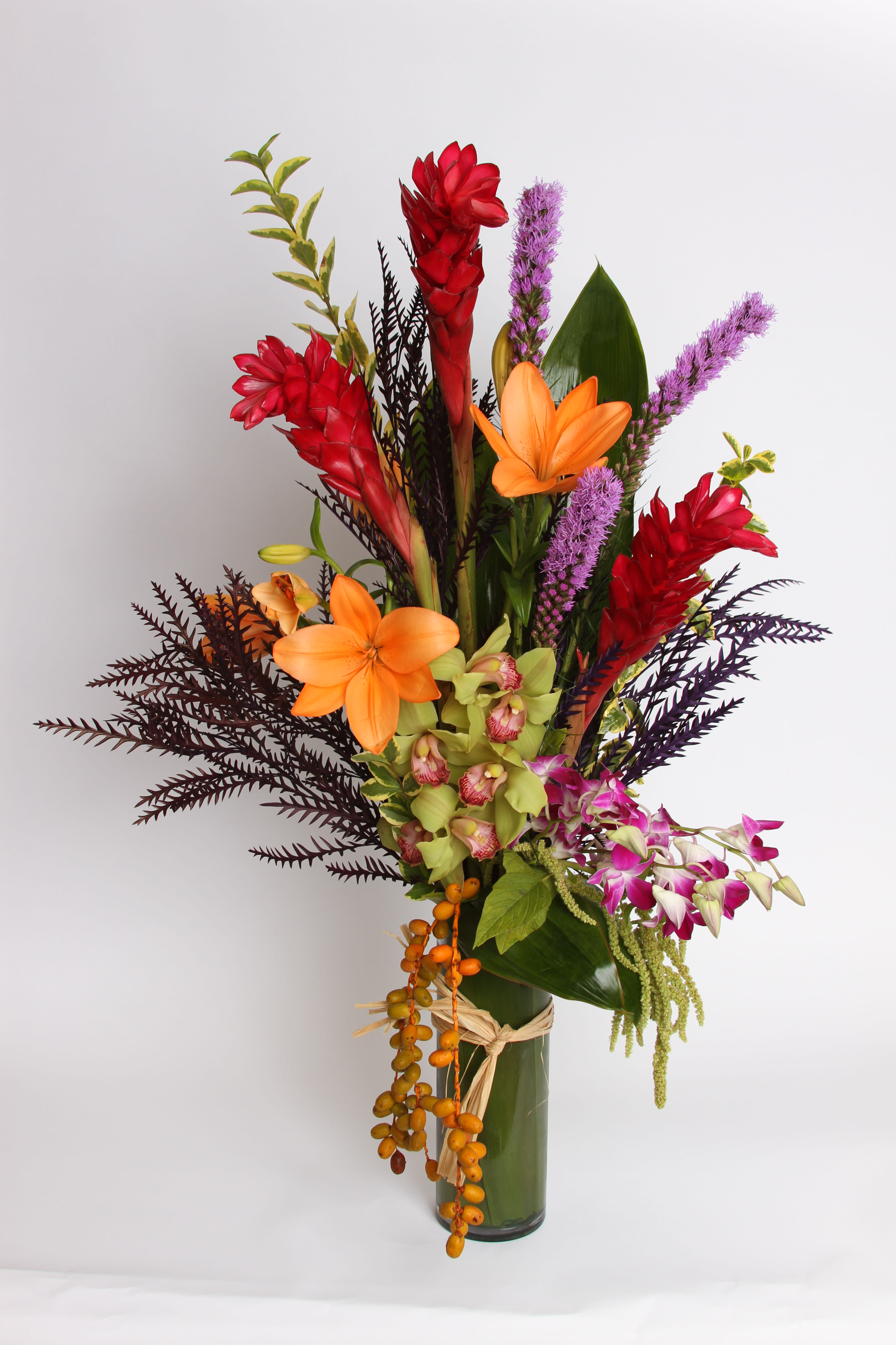 Touch of the Tropics Touch of the Tropics - A tropical vase arrangement from our Fall Collection with cymbidium orchids, ginger, liatris,orential lilies, dendrobium orchids and berries