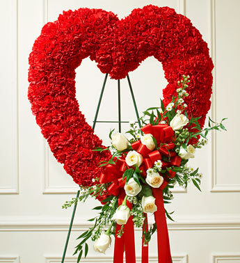 Red and White Open Heart with White Roses -  Product ID: 91242   Send a tribute that reflects your undying love and heartfelt sympathy. Flowers such as white roses, red carnations and more Open heart with oasis in mache, tied to the wire easel with satin ribbon Sent directly to the funeral home by family and friends Due to the sensitivity of the occasion, our florists use only the freshest flowers available so components may vary Measures approximately 26&quot;H x 28&quot;D