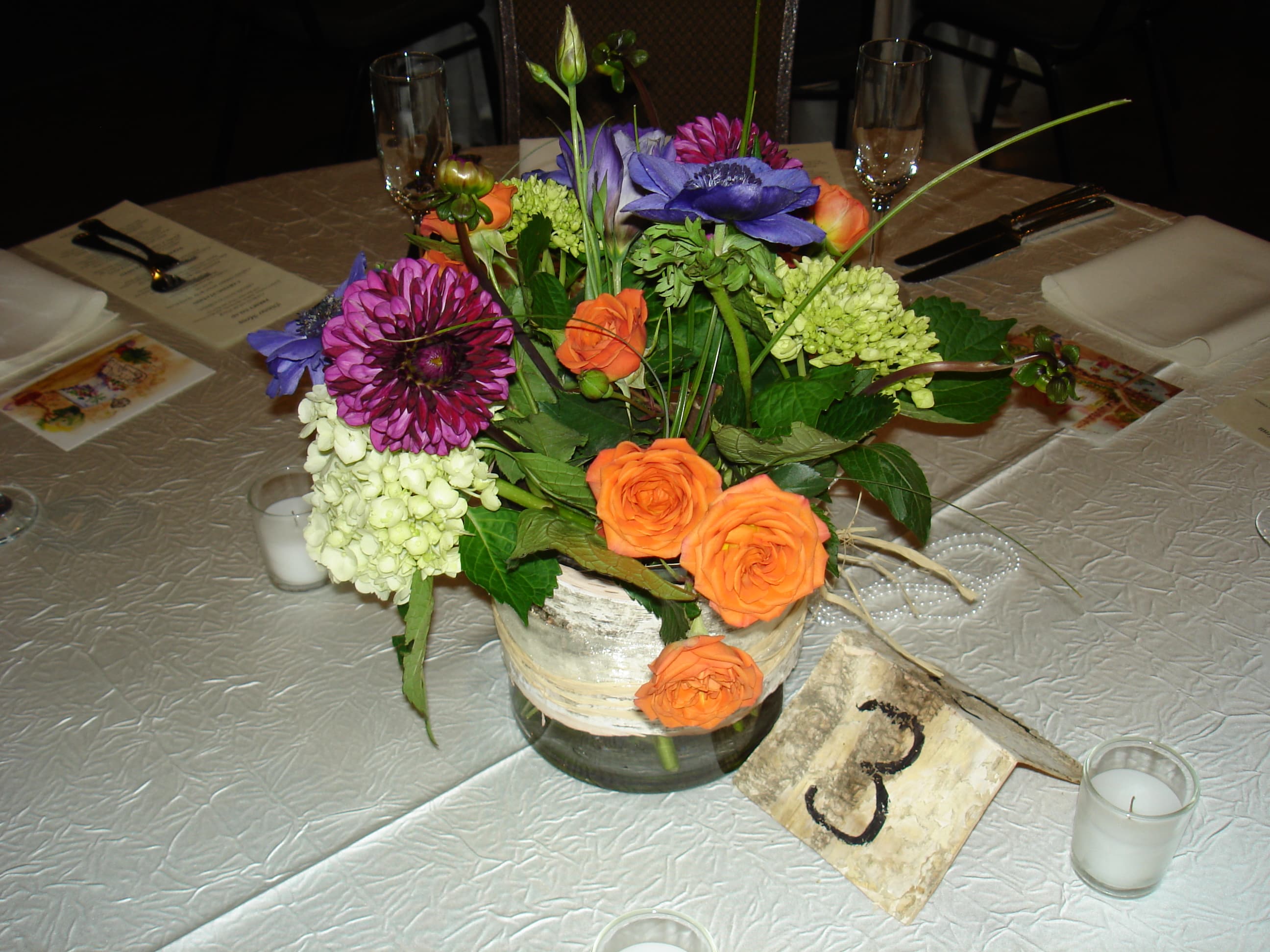 Say Hello! Say Hello! - 6|" cylinder vase with seasonal flowers, tulips, lilies, dahlia, wax flower, stock, depending on availability approx. 12" width, 12" tall , all around design