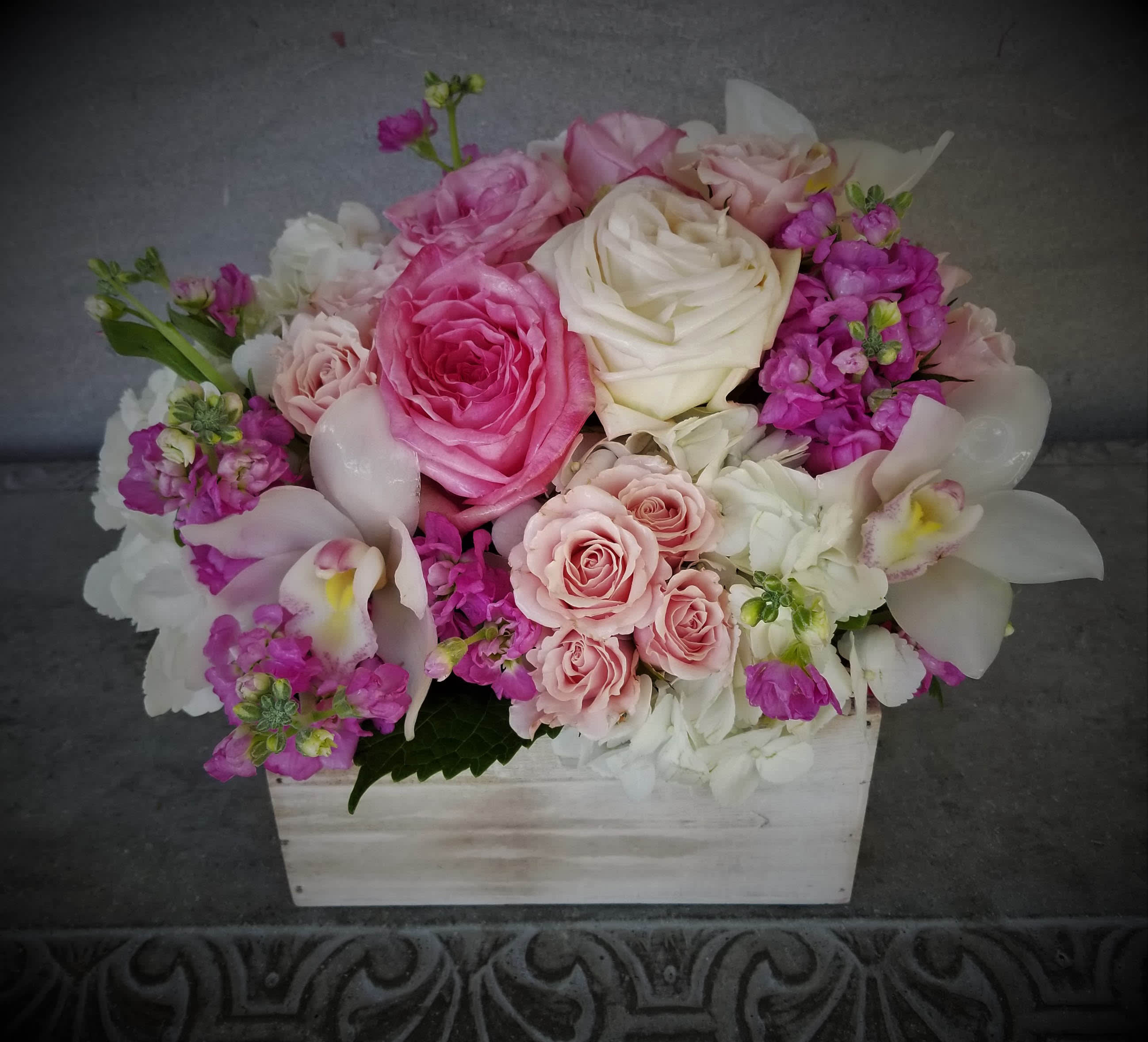pretty pink box -  romantic arrangement with roses and orchids in wooden boxwoodbox