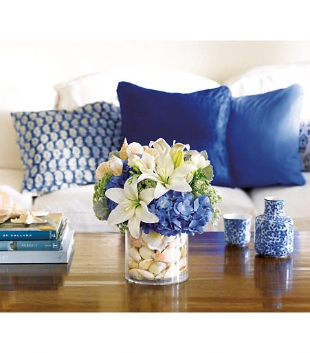 Beach Lovers Beach Lovers - Blue hydrangea, white asiatic lilies, freesia, queen anne's lace arrive in a surprise inside vase with stones