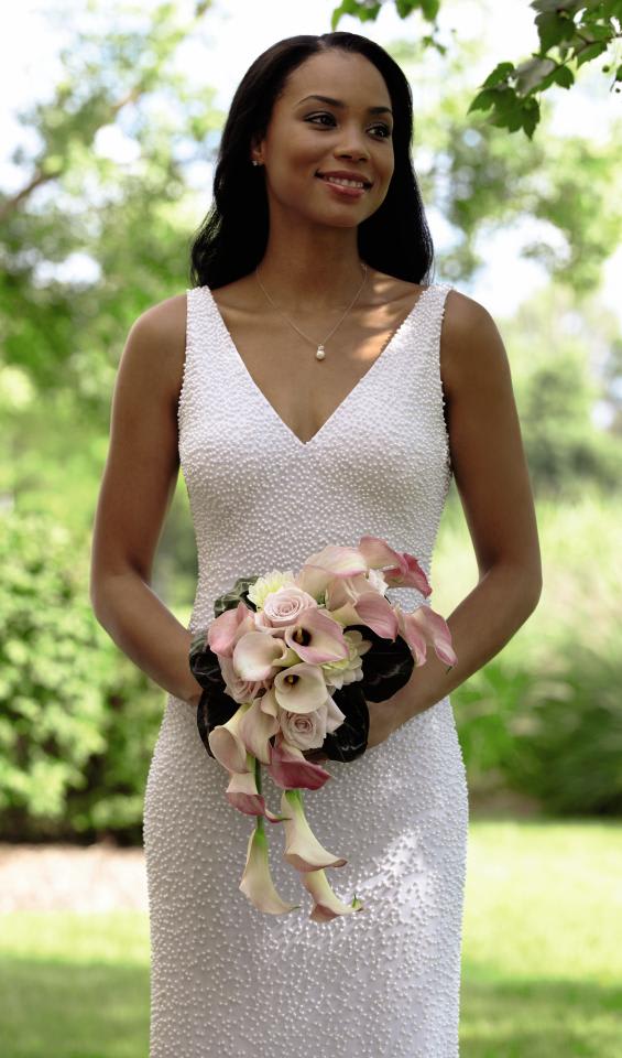  Pink Cascade Bouquet - The Pink Cascade Bouquet exudes pure elegance and feminine charm.  Pale pink mini calla lilies, roses and dahlias are arranged in a cascade  style and accented with a white taffeta ribbon to create an  unforgettable look. Approx. 20âH x 11âW. 