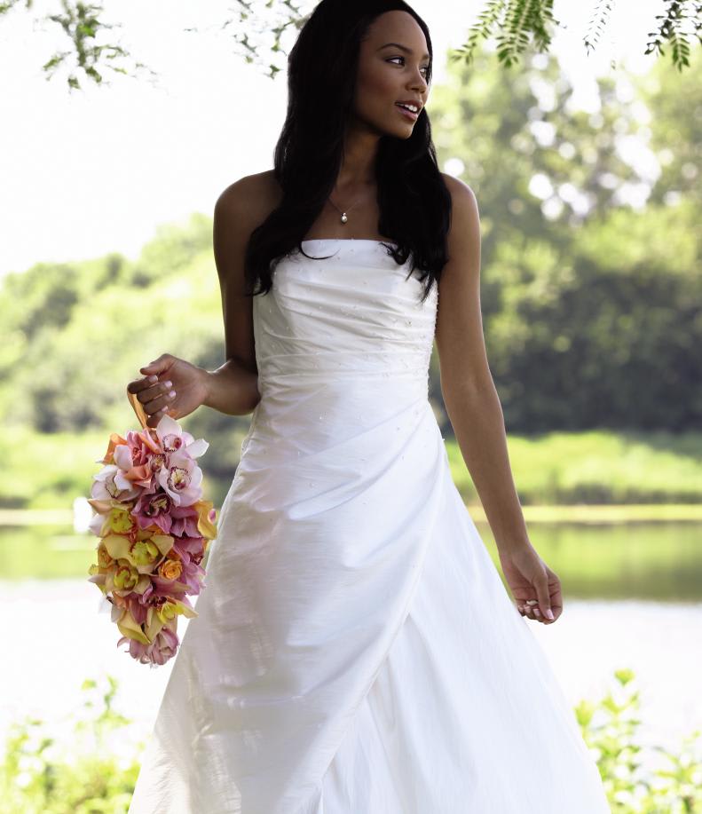 FTD Delicacy Bouquet - The FTDÂ® Delicacyâ¢ Bouquet is a fresh take from the standard wedding  bouquet. Created with the fashion forward bride in mind, this bouquet of  yellow mini calla lilies, orange spray roses, pink cymbidium orchids,  pale pink mini cymbidium orchids, and gold cymbidium orchids are  gorgeously arranged to delicately hang from a pale apricot satin ribbon,  making it easy to hold and memorably beautiful. Approx. 15âH x 6âW. 