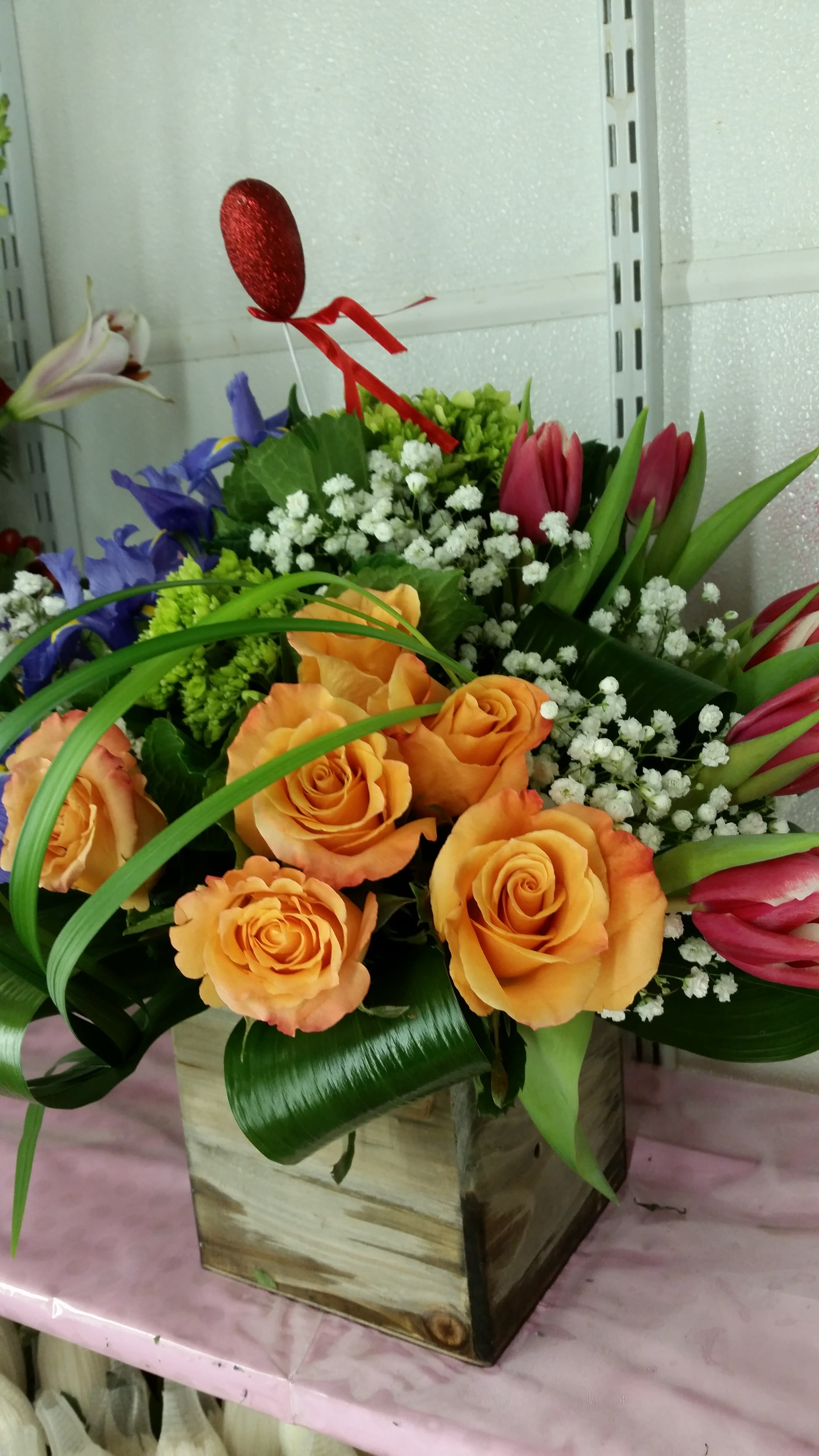 wooden cube wooden cube - tulips, orange roses, iris, green hydrangea with a touch of baby breath