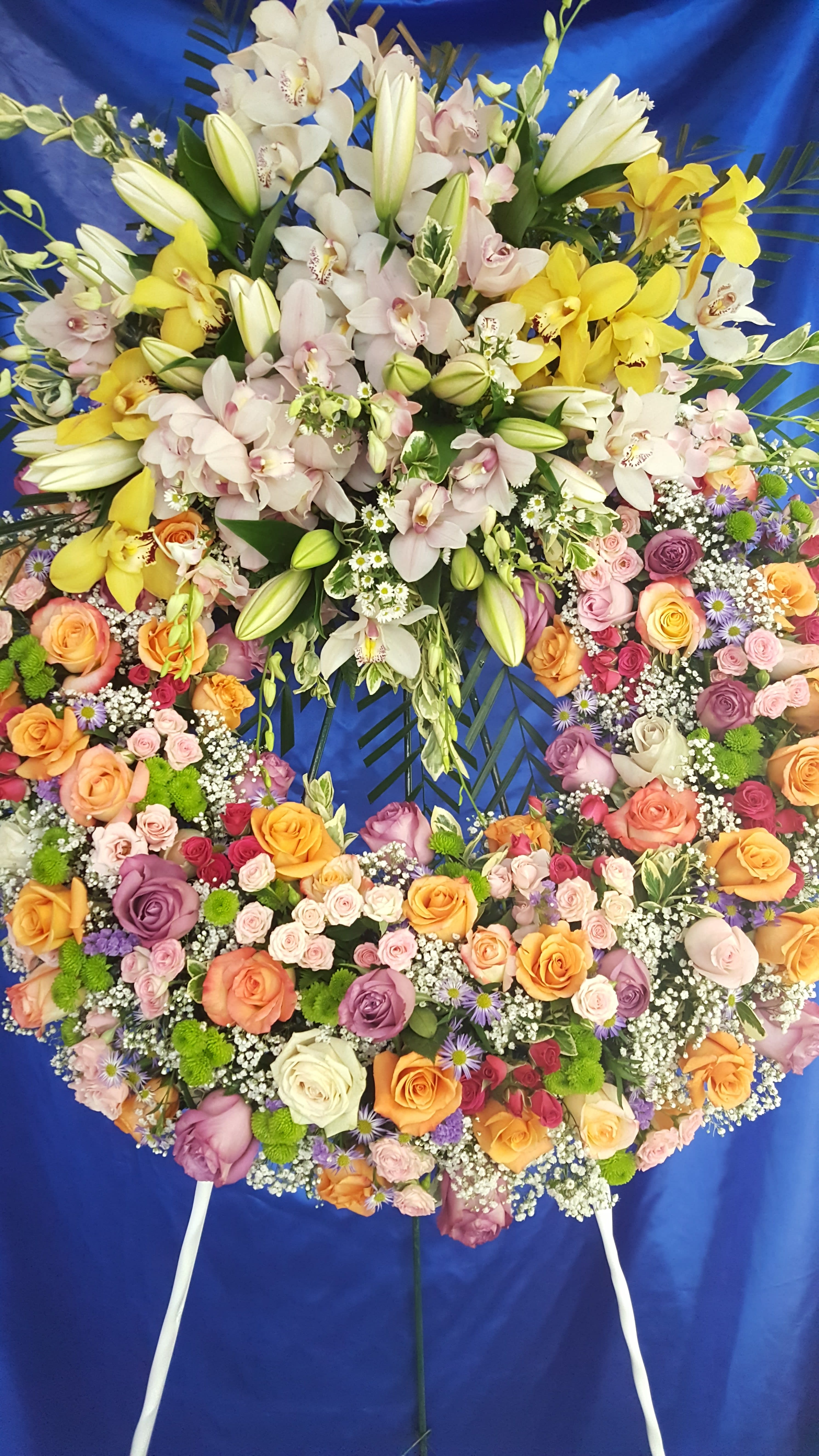 mix flower wreath - mix color roses, purple monte casino, pink cymbidium, white lilies and white dendrobium