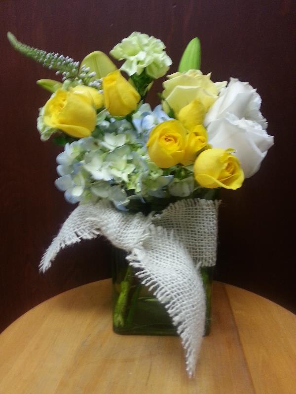 Pastel Memories Pastel Memories - A large stem of hydrangea is filled with roses , carnations, and lilies in pastel colors accented with a burlap tie.