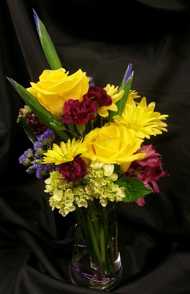 My Iris is on you! - Bright yellow roses and daisies are accented with hydrangea, alstromeria  and carnations. To top them off 3 iris stems are keenfully keeping an eye them.