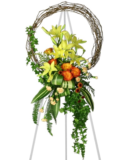 Garden Pathway - Honor your loved ones sunny personality with this stunning wreath display. Ivy, fern, yellow lilies, yellow and orange roses, and rust botton poms make up this charming wreath.