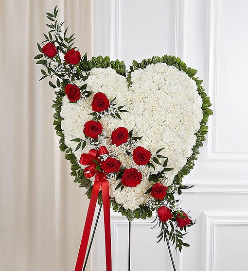 91277 91277 - Though taken from this world, they will live forever in the hearts of many. Let our grand standing heart arrangement be a reflection of this touching sentiment. Handcrafted by our caring florists using a bed of white carnations and a cascade of radiant red roses, it’s a beautiful tribute best suited for the funeral services.