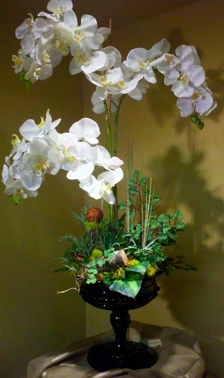 Orchid Elegance Orchid Elegance - This elegant faux orchid is an art piece to view and enjoy. It's graceful expanse will embellish any area you desire. Great for an entry table, side board, or anywhere else. Easy mainentance with an incredible life span.
