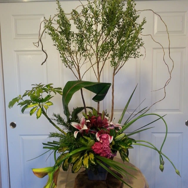 Swirling Journey - The mixture of foliage and flowers, used in a contemporary way, give this design the style that represents you!  Send this for a loved one or order for your party to impress your guests.