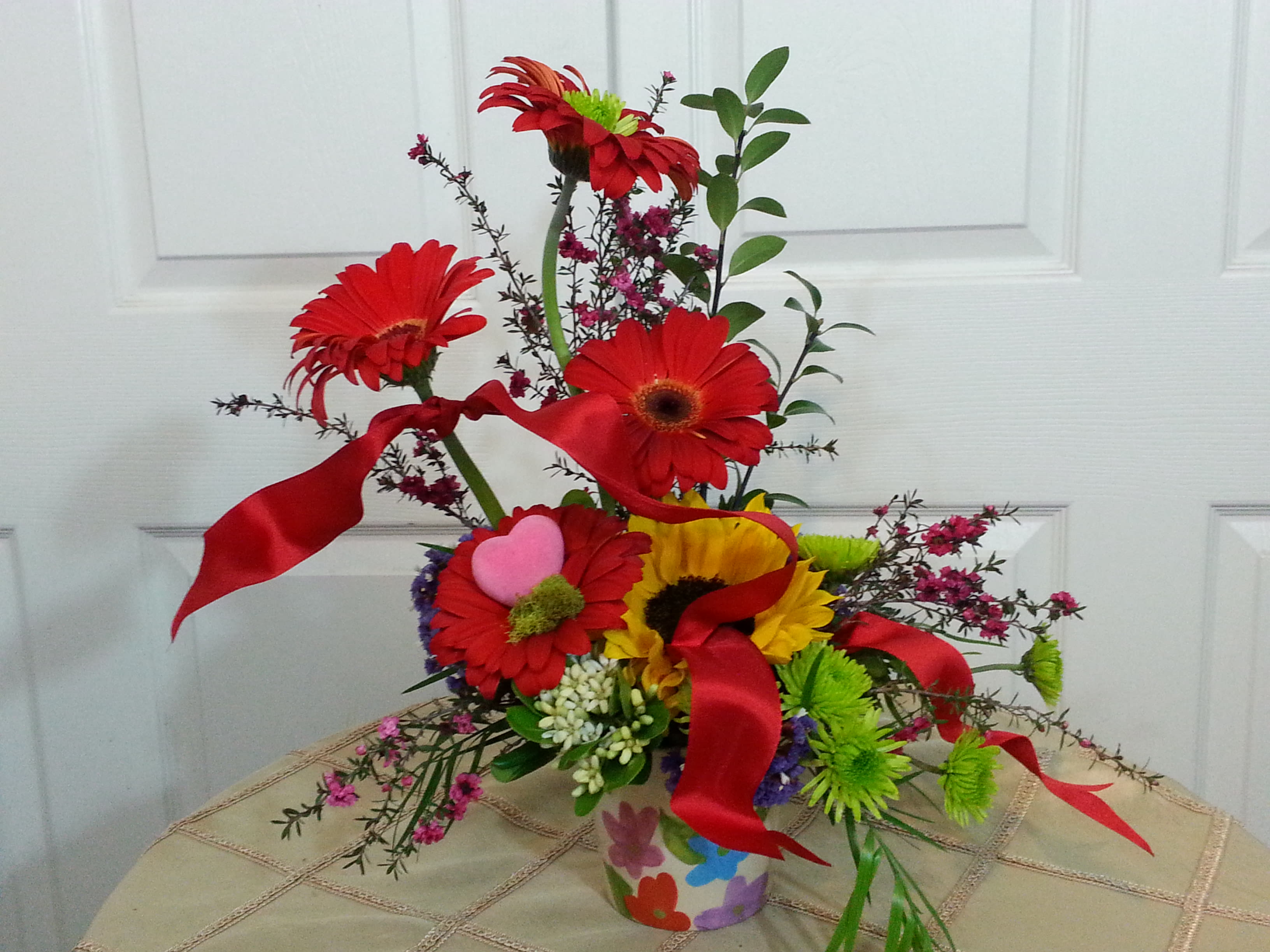 Gerbera Surprise! - A colorful arrangement to brighten anyone's day, featuring the ever loved gerbera daisy.....if gerbera aren't available, I will substitute with another happy flower!