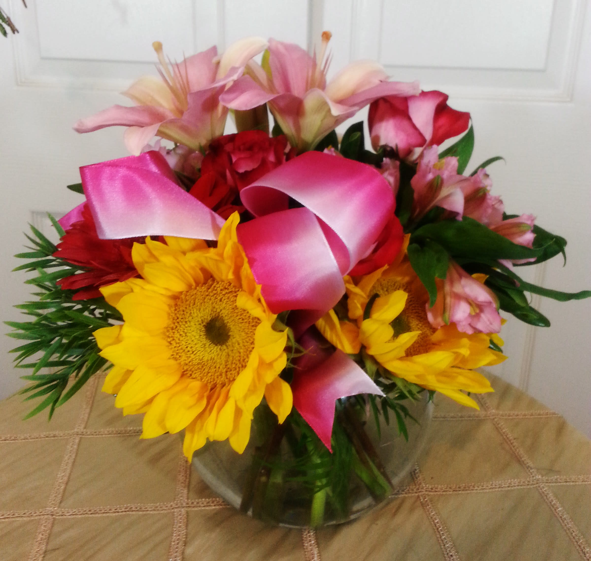 Sunshine Bowl - A beautiful array of spring flowers nestled in a glass bowl says so much to your loved ones and friends.  The mixture of textures is so inviting anywhere this is set.  I can easily change up the colors to suit your Thanksgiving, Christmas, or Holiday needs.