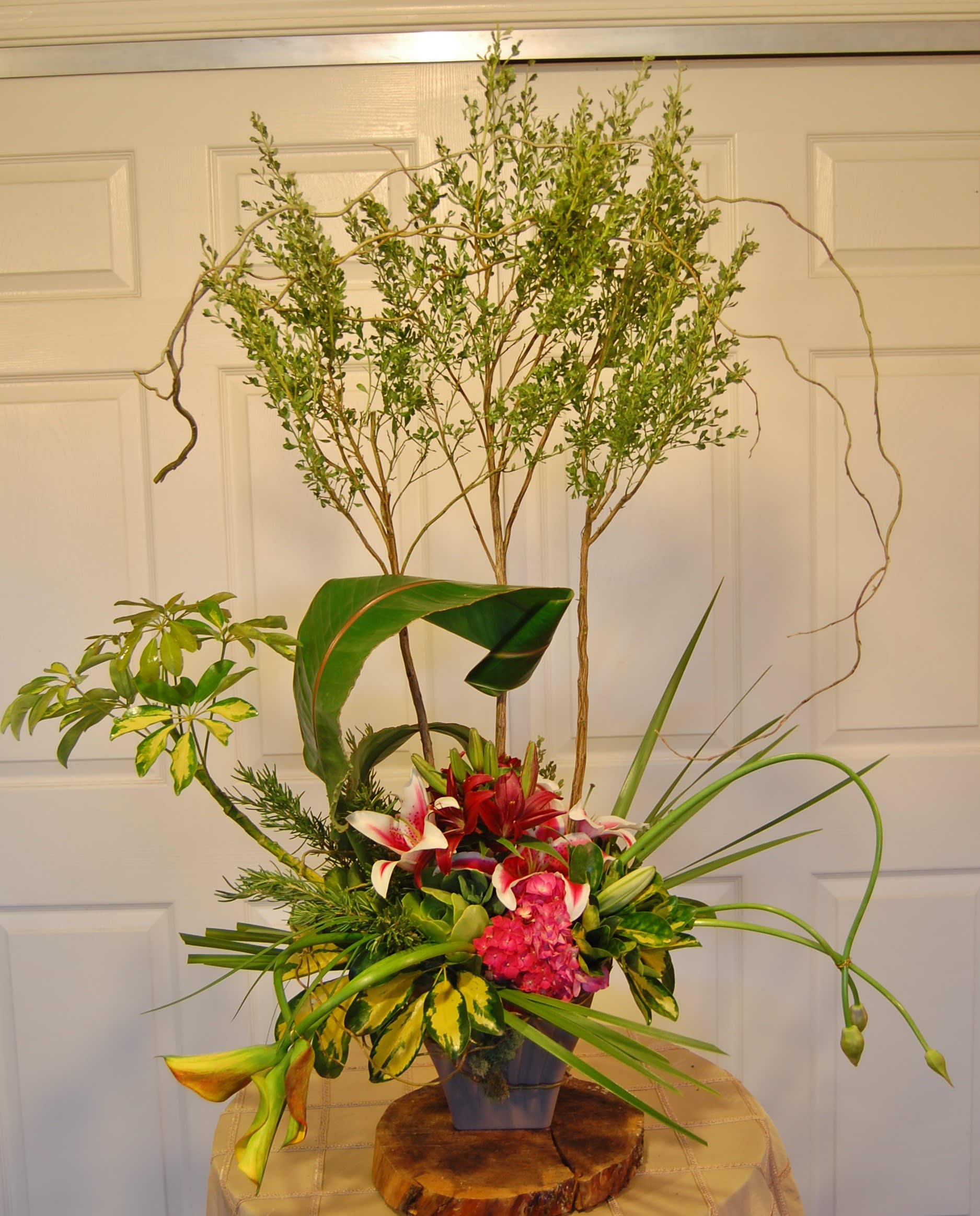 Modern Splendor - A cool, creative arrangement of mixed flowers and foliage.....an artful treat for this special occasion....
