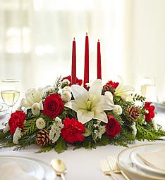 Centerpiece Tradition - A beautiful display of red and white flowers with tapered candles to adorn any holiday table.  Let Joe change things up for a more creative look!