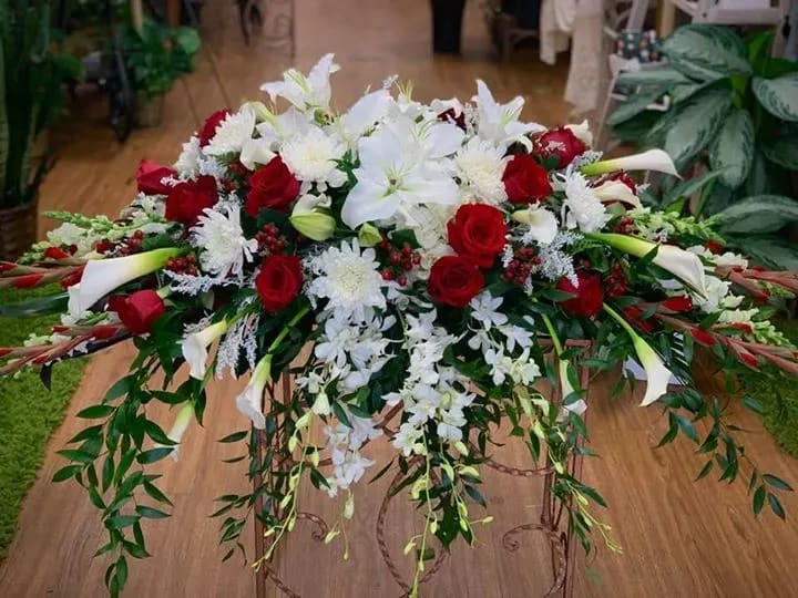 Casket spray of red and white - Elegant and beautiful......a favorite of mine.  With orchids, roses, and much more, this will represent your loved one's journey.