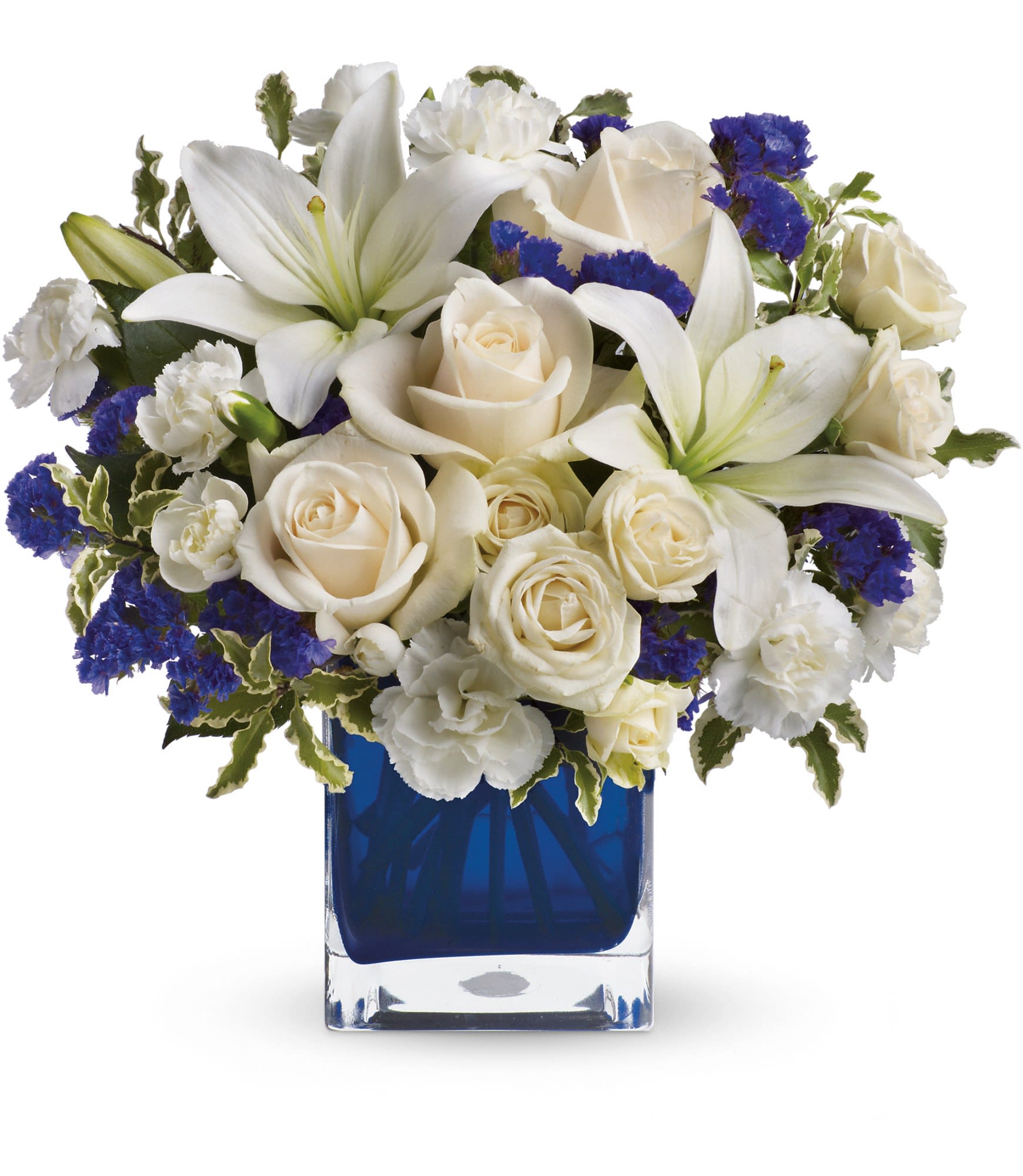 Teleflora's Sapphire Skies Bouquet - Send someone a bit of heaven with this beautiful bouquet. Luxurious crÃ¨me roses and pure white lilies paint a peaceful picture inside a sapphire blue cube.  