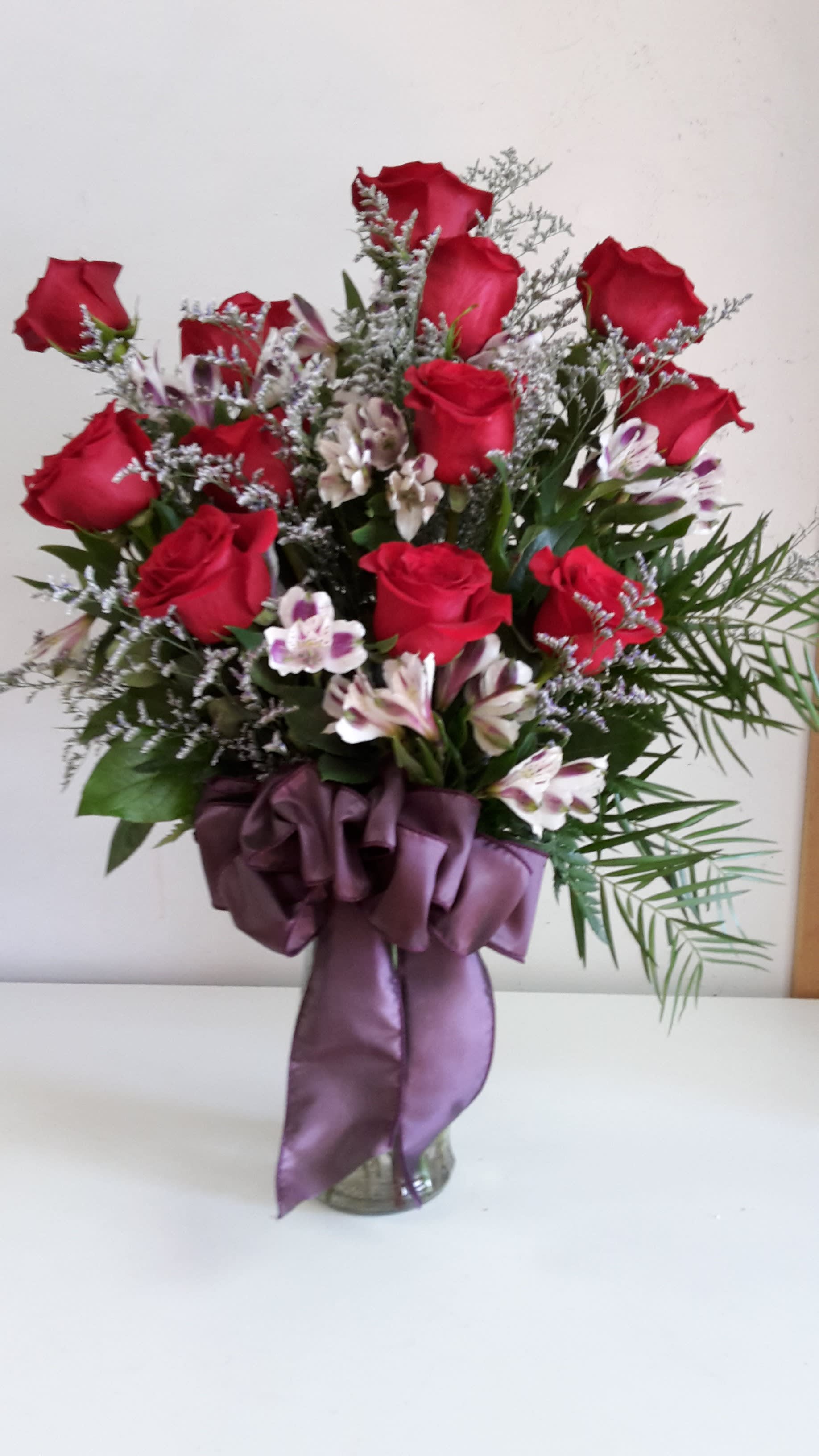 A Dozen Deluxe Roses - For the perfect, traditional Valentine’s Day bouquet – or for a birthday, anniversary or other special day – this bouquet of a dozen red roses adorned with a classic mix of accent flowers and greenery is a classic gift of love. Send it today, and she’ll love you forever. Available in many colors.