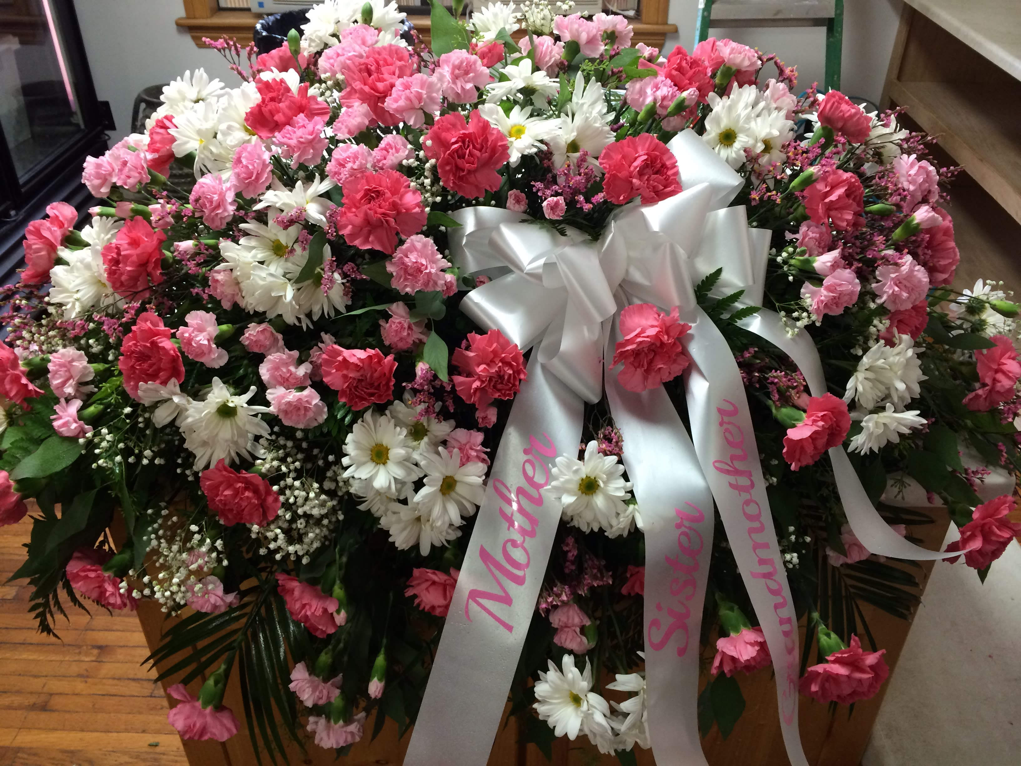 Pinks &amp; White Fresh Casket Spray - Carnations &amp; Daisys in many shades of pink &amp; white.