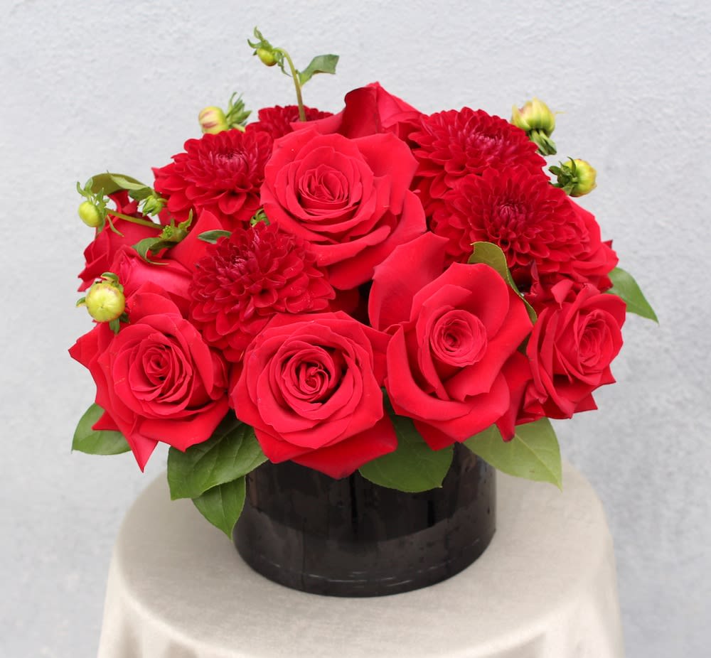 Roses and Dahlias if available can replace with other  beautiful flower. - Gorgeous red roses and red dahlias in a black glass vase. 