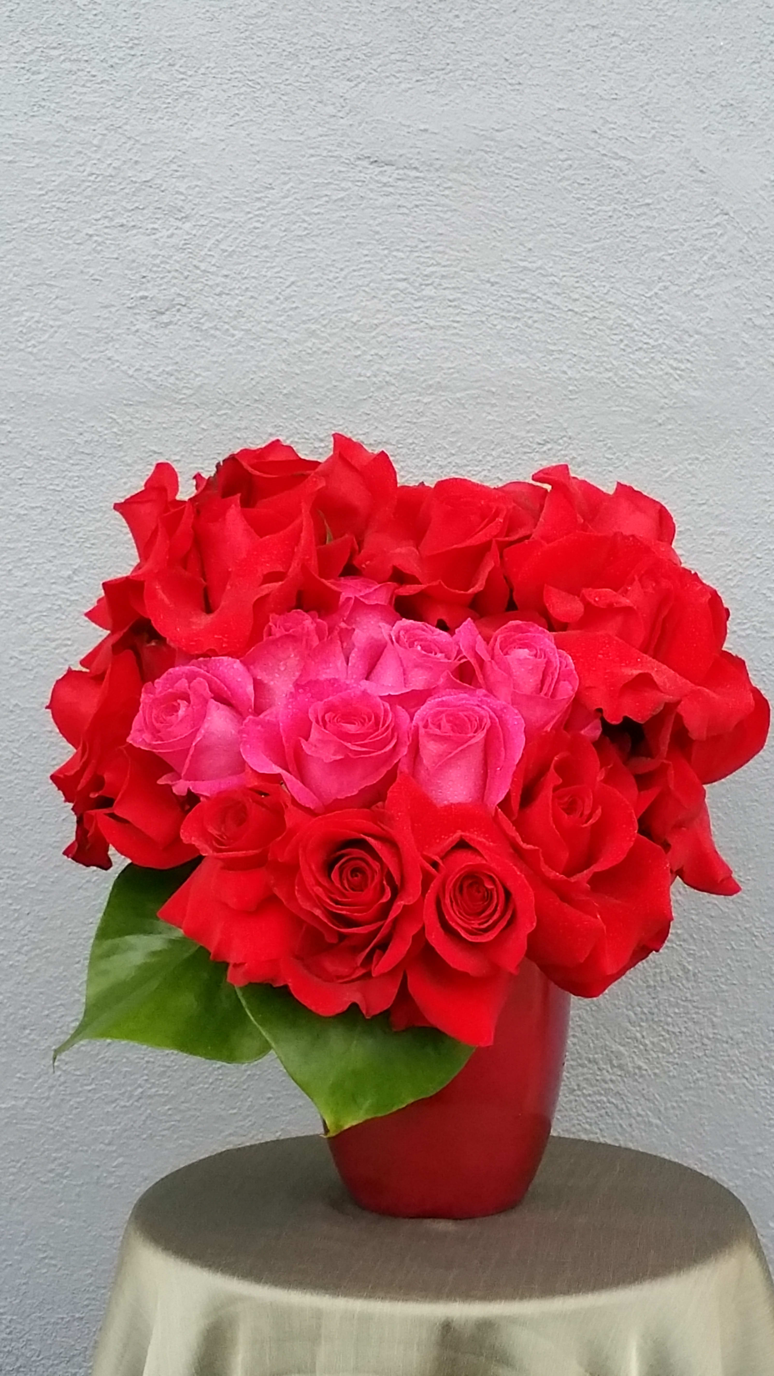 open heart - Dark red roses and hot pink roses in a candy apple ceramic container