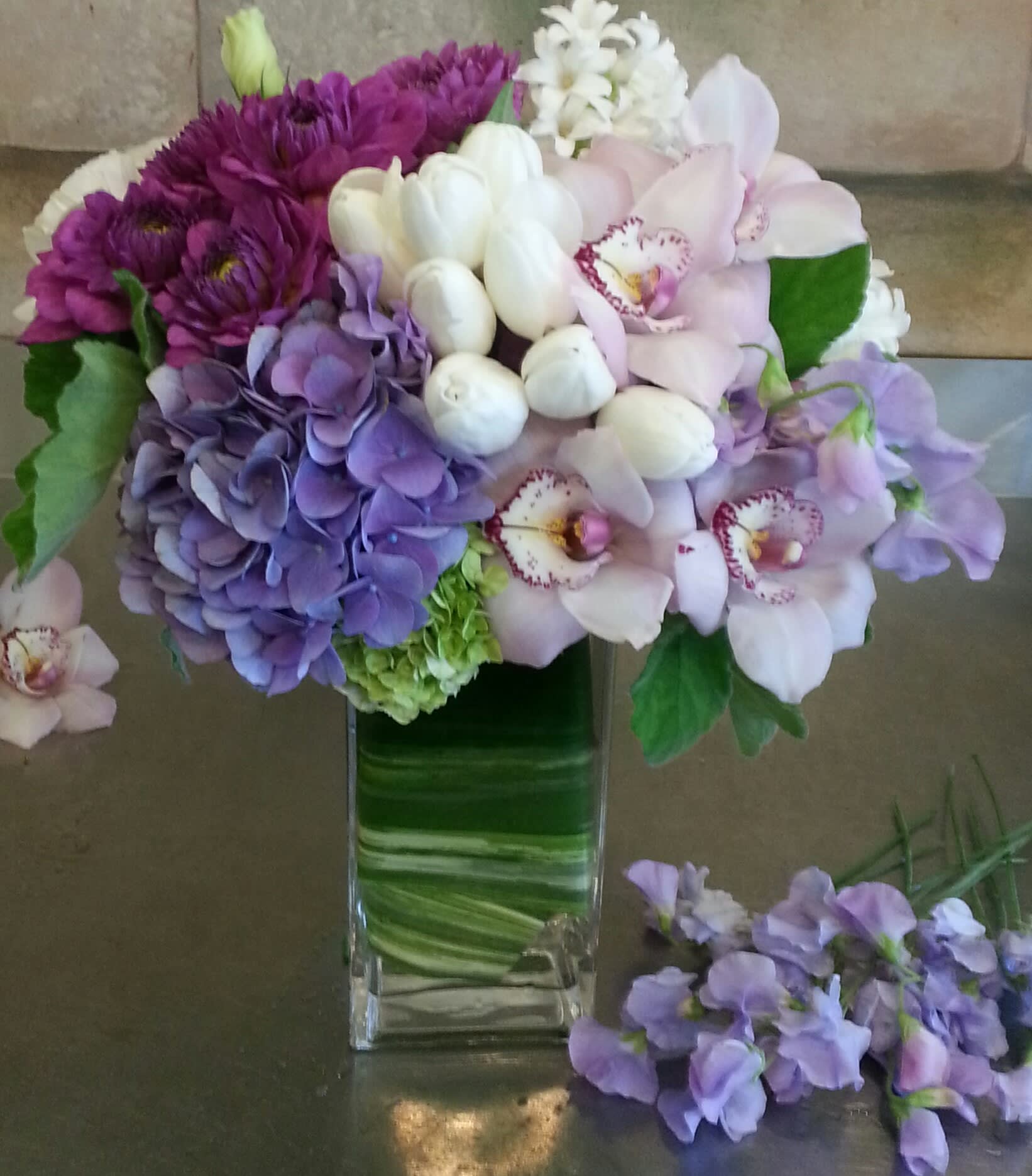 Pleasantry - Green hydrangea, tulips,  sweet peas, tropical orchids, daliahs and hyacinth 