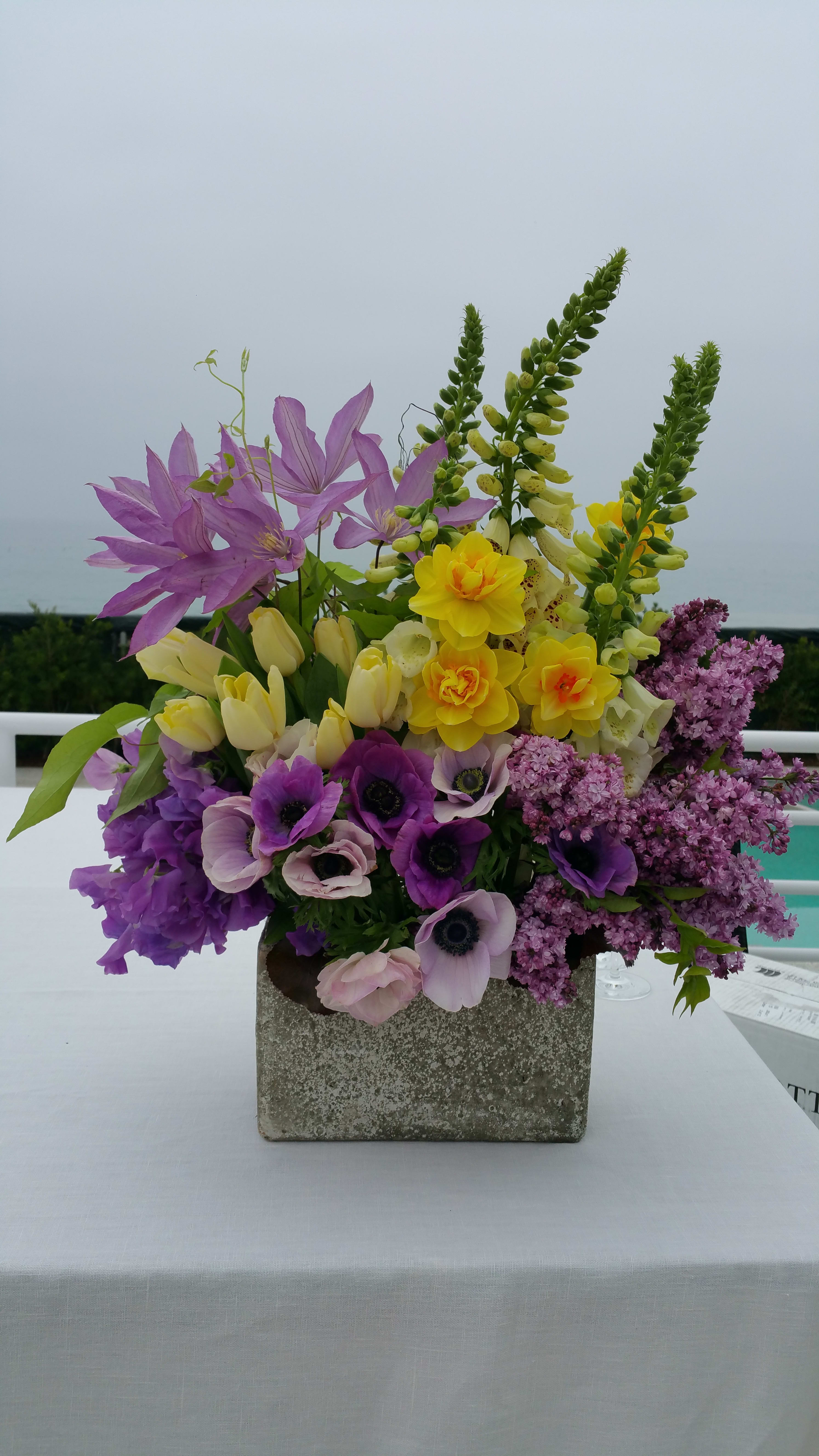 fleurish - Combination of fresh spring flowers cluster in stone container