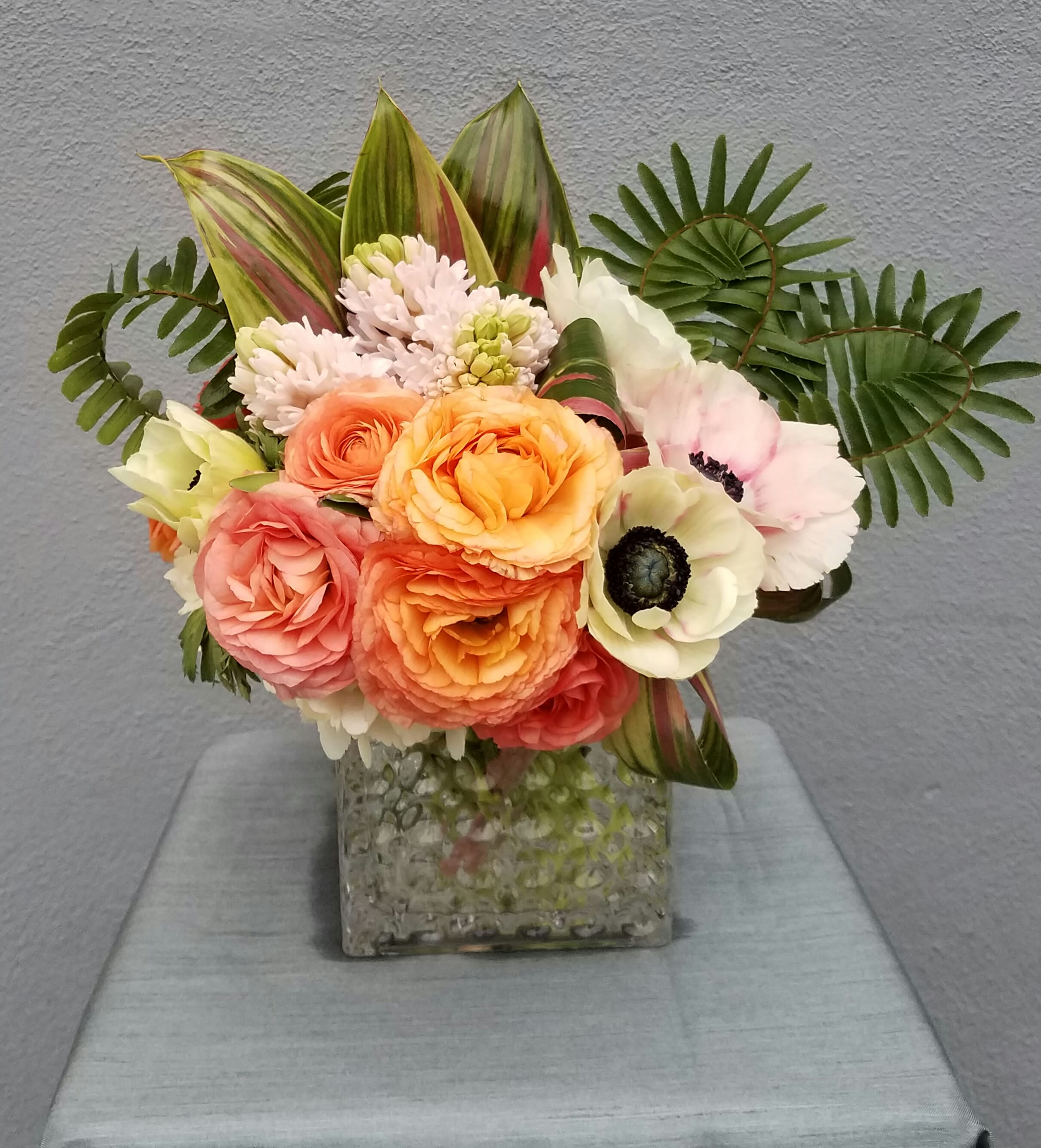 Joyful - ranunculus,anemones, hyacinth and tropical leaves in a modern bubble pattern vase