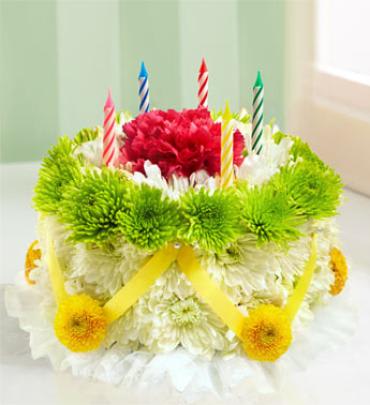 Birthday Flower Cake - Green and Yellow Birthday Flower Cake - Green and Yellow - Our signature floral birthday cake may look good enough to eat, but it's actually crafted from fresh mini carnations and poms, and can last for days after their celebration is complete. Now with a new green and yellow recipe. (Vase/Basket style may vary) Item # 91429