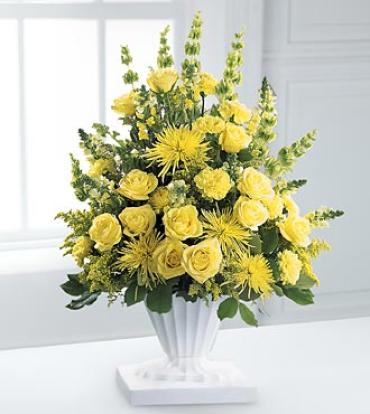 Glowing Ray Arrangement Glowing Ray Arrangement - The Glowing Ray Arrangement will express your heartfelt sympathies. Luscious yellow blooms - roses, carnations, snapdragons and spider chrysanthemums - are beautifully designed and accented by Bells of Ireland and greenery. Item # S5-3790