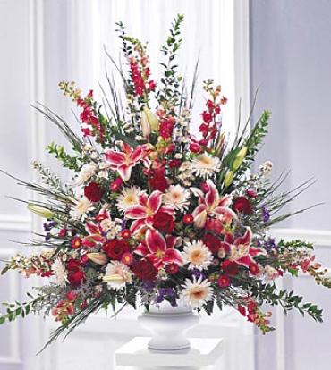 In Our Thoughts Arrangement In Our Thoughts Arrangement - Red roses and pink Stargazer lilies, bright pink snapdragons and Matsumoto asters, are just a few of the lovely blossoms in this extravagant arrangement. Limonium and purple statice with assorted greens serve as accents. Design is one-sided and is appropriate to send to the funeral home or memorial service. Item # S2-3792