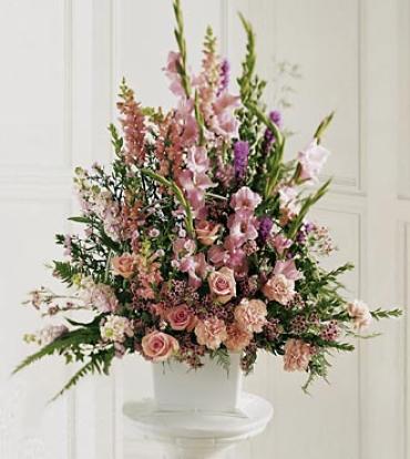 Peaceful Memories Arrangement Peaceful Memories Arrangement - The Peaceful Memories Arrangement features beautiful flowers in many shades of pink to offer your sympathies. This rectangular white handled basket holds all pink gladiolus, roses, snapdragons, and carnations with accents of pink waxflower, monte casino and assorted greenery. Item # S3-3475