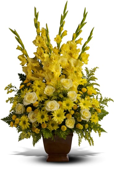 Sunny Memories -  Celebrate your sunny memories of someone special with this tall funeral floral arrangement, presented in a graceful urn. The sunny yellow flowers are a classic statement of never-ending friendship and love.    Item # T219-1A 