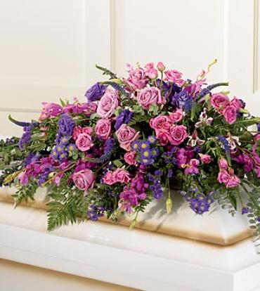 Blanket of Flowers Casket Spray Blanket of Flowers Casket Spray - The Blanket of Flowers Casket Spray is abundantly made of jewel-toned pink and purple blooms. Hot pink and lavender roses, fuchsia orchids, purple lisianthus, purple Veronica and purple statice are accented with baby blue eucalyptus for a stunning blanket of flowers for your loved one. Item # S17-4220