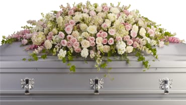 Always Adored Casket Spray Always Adored Casket Spray - A graceful and magnificent cascade of delicate pale pink, white, and crème flowers conveys everlasting affection for the radiant spirit being honored, and gently eases sorrow for those paying respect. Item # T236-3A