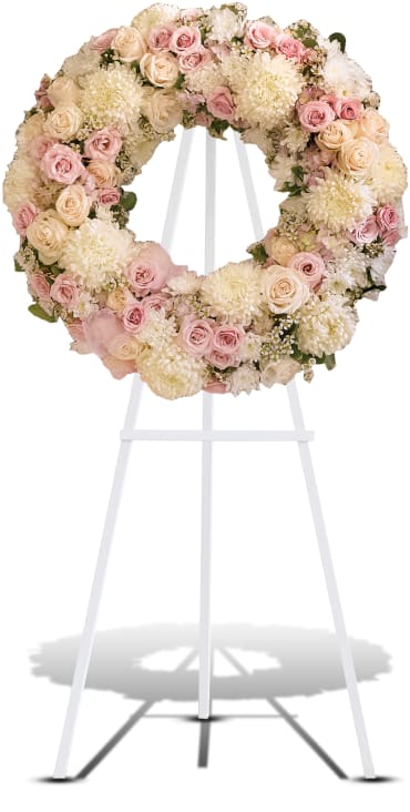 Peace Eternal Wreath Peace Eternal Wreath - A pure and delicate expression of adoration. Accented with a sheer pink organza bow, this wreath of white, crème, and pale pink petals gently embraces loving memories, and offers solace and sweet thoughts at a time of loss. Item # T236-1A