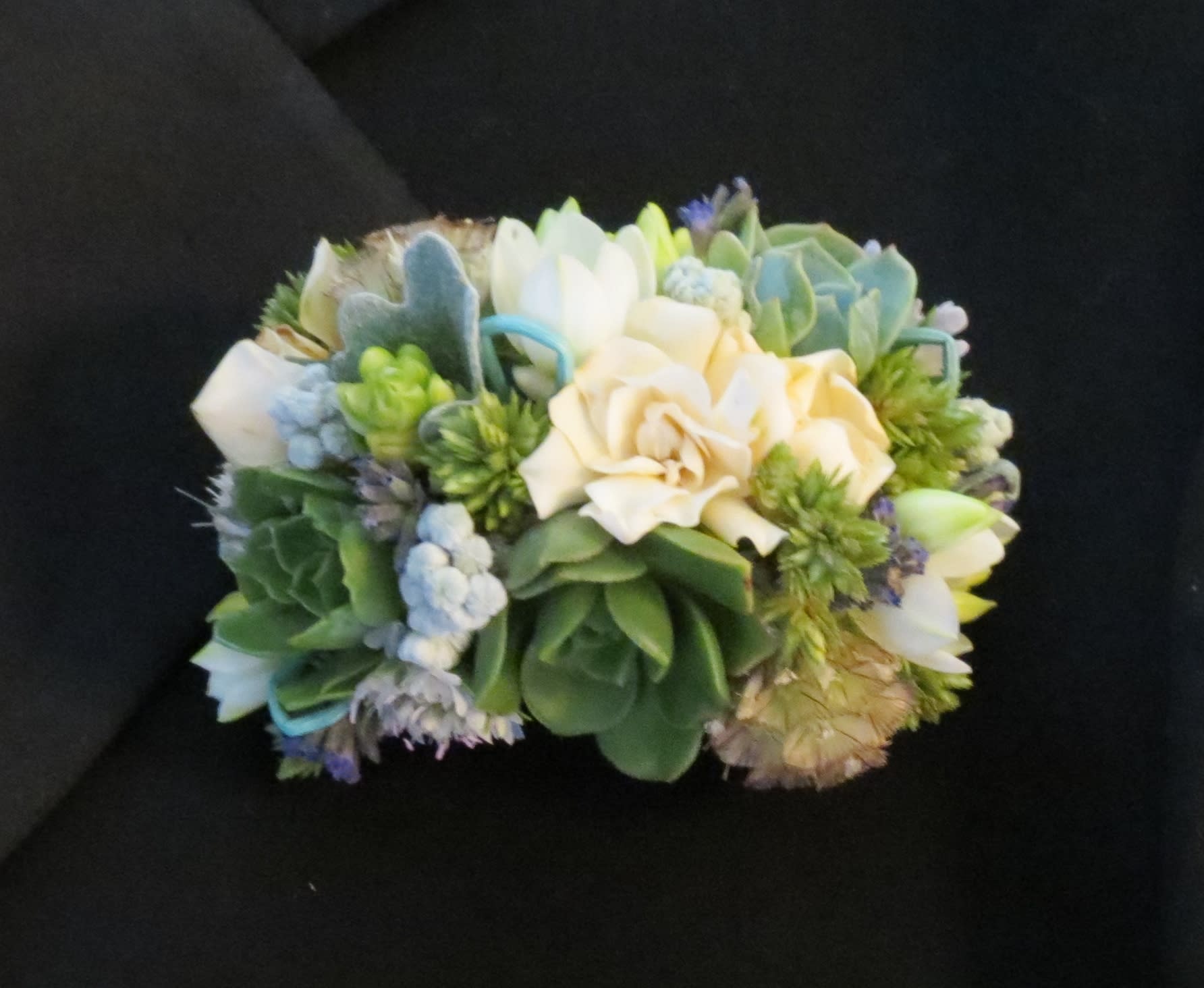 cuff corsage cuff corsage - Seasonal flowers arranged to create a unique cuff corsage.