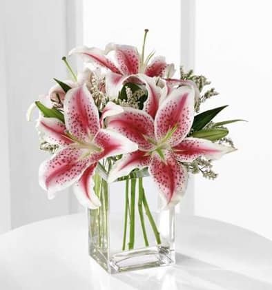 The FTD Pink Lily Bouquet - Send this sweet bouquet as an expression of your sympathy. Fragrant pink Stargazer lilies are accented with pink statice and arranged in a clear glass vase.
