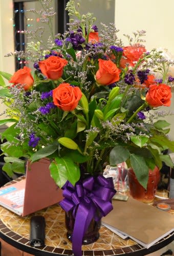 Heavenly Touch - Orange Roses, Purple Stock, Statice, Yellow Lilies and more in this spectacular arrangement
