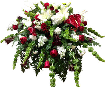 Embrace - Flowers Included:  Roses: 12 (Giant, 24) Molucca Balm: 10 (Giant, 16) Safari Sunset: 12 White Stock: 5 (Giant, 8) White Carnations: 8 White Lilies: 3 (Giant, 5) White Hydrangea: 3 (Giant, 5) Heart Authurium: 4 Red Hybericum Berries: 5 Green Button Poms: 5 Also Included:  Vase &amp; Greenery