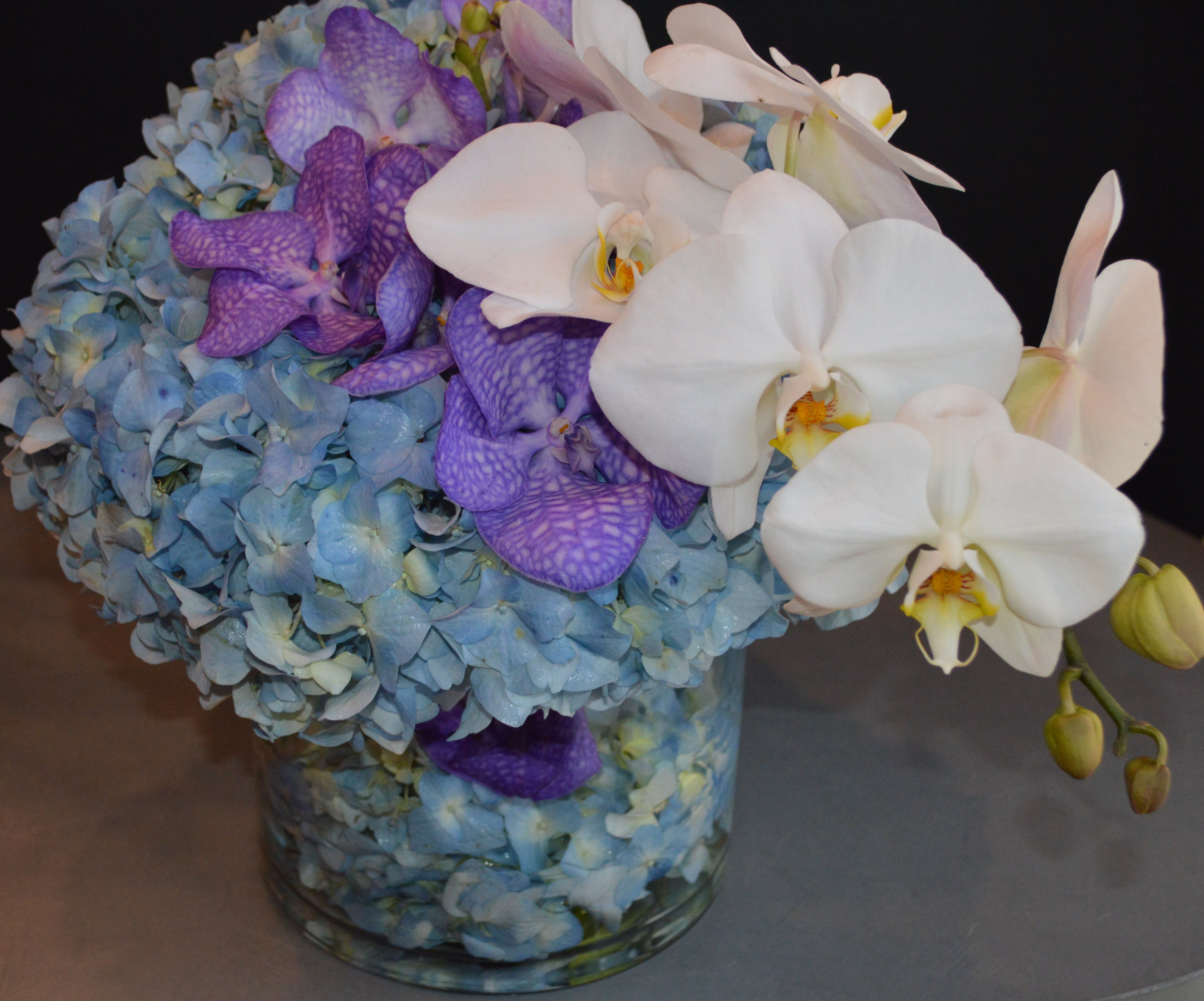 Why so bleu? - hydrangea, phalaenopsis, &amp; vanda orchids in a glass cylinder.